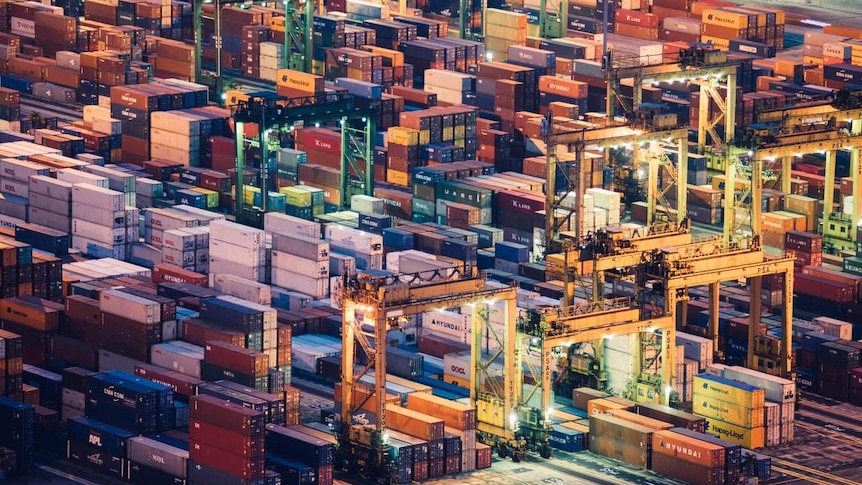 Shipping containers at a port at night.