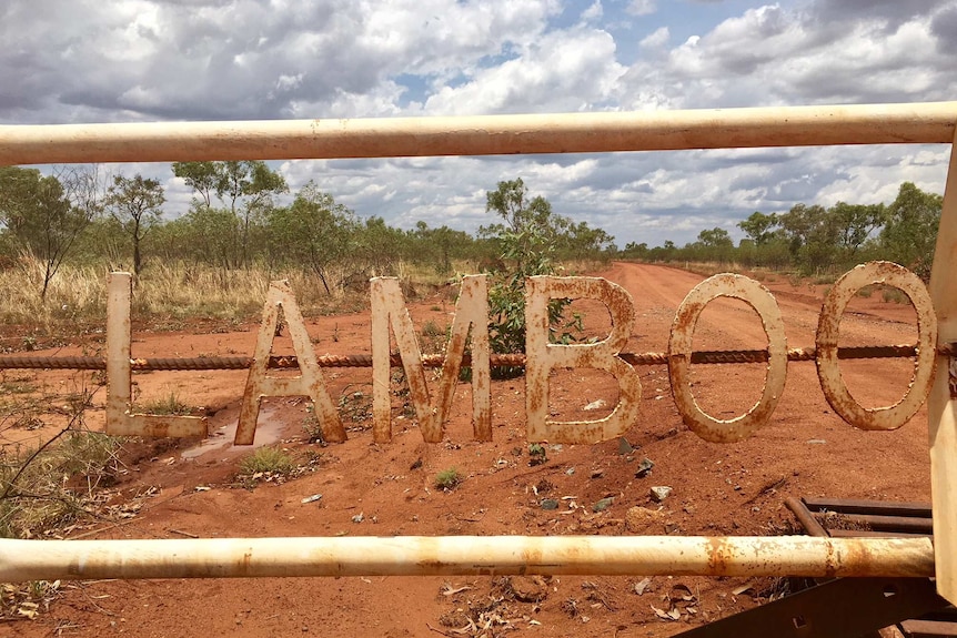 An outbreak property with a dirt road and a sign on the gate saying Lamboo Station