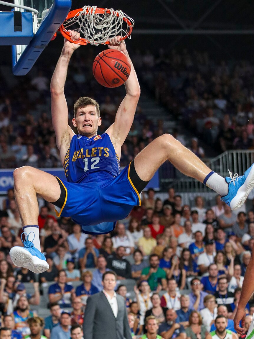 Brisbane Bullets player Will Magnay dunks the ball.