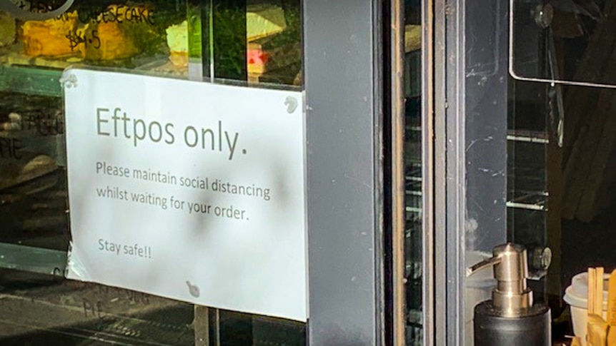 The front of a cafe with an Eftpos payment only sign.