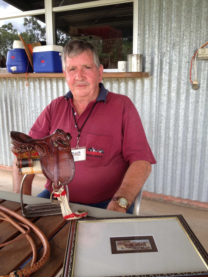 Cigarette paper artist Bob Wilson from Blackall in western Qld with one of his paintings