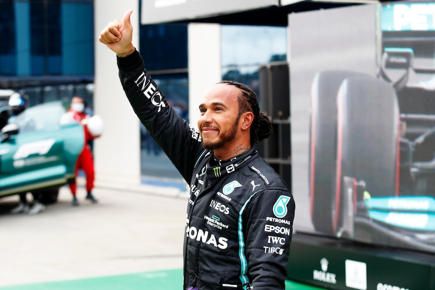 Lewis Hamilton with thumbs up to a crowd.