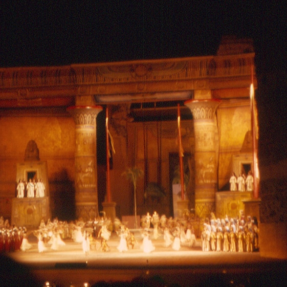 A photograph of a production of Verdi's Aida at night at the Baths of Caracalla in Rome. 