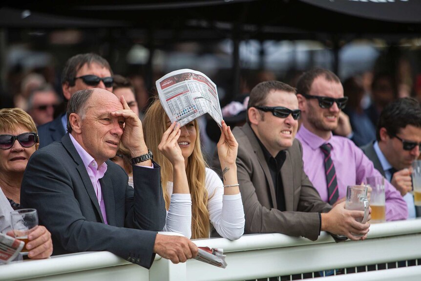 Punters are seen during UBET Stradbroke Day at Doomben Racecourse in Brisbane, Saturday, June 9, 2018.