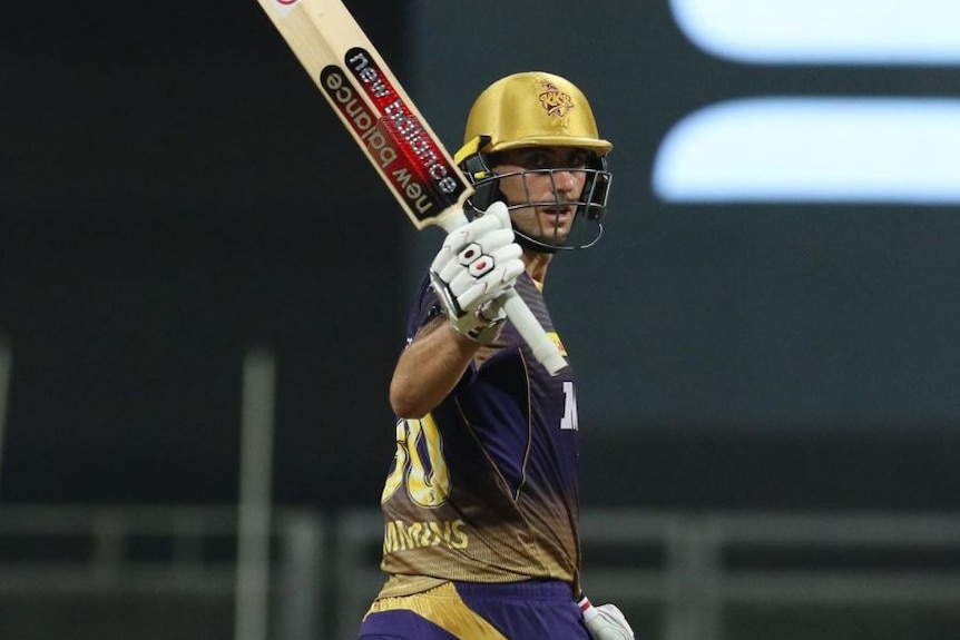 Pat Cummins raises his bat while playing in the Indian Premier League for Kolkata Knight Riders.