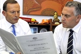 Opposition Leader Tony Abbott (left) and shadow treasurer Joe Hockey discuss the Coalition's budget reply speech.
