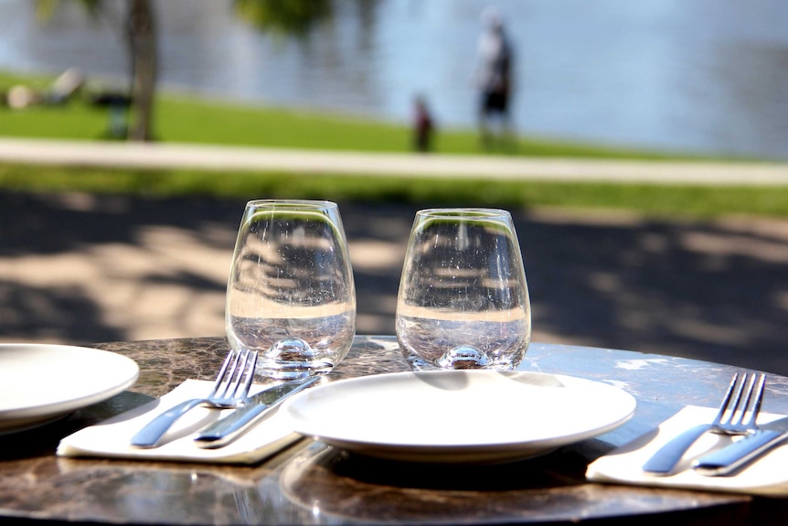 Set up table at an outdoor cafe.