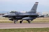 US F-16 fighter jet takes off from tarmac.