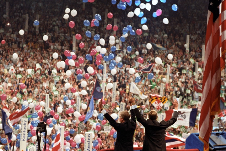 Jimmy Carter looks out at the crowd of people as red, blue and white balloons rise at the end of the 1980 Democratic convention