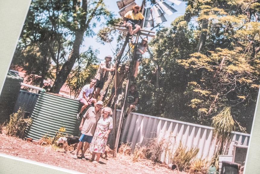 A couple next to a windmill that once stood in their backyard.