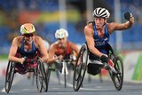 Two American wheelchair athletes celebrate after crossing the line to take gold and bronze in a 1,500m race.