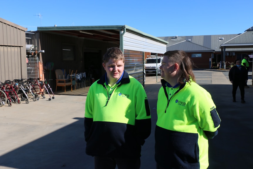 Tyler and Peter wearing high vis shirts at work, chatting with smiles. Ausnew Home Care, NDIS registered provider, My Aged Care