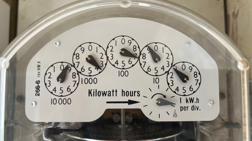 Close up shot of electricity meter with analogue dials showing usage