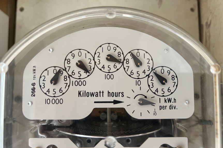 Close up shot of electricity meter with analogue dials showing usage