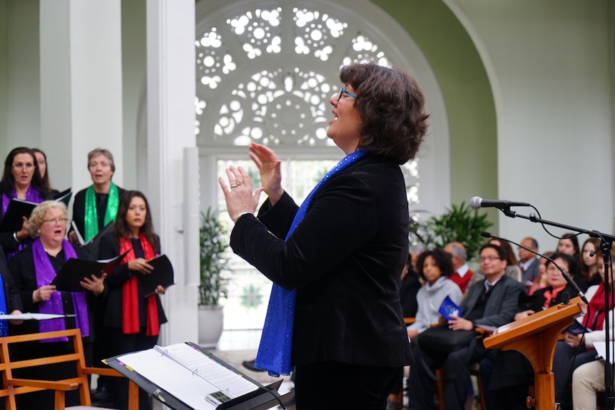 Lorraine Manifold conducting a choir