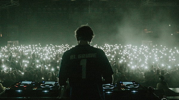 press shot of RL Grime performing to a crowd holding up their mobile phones