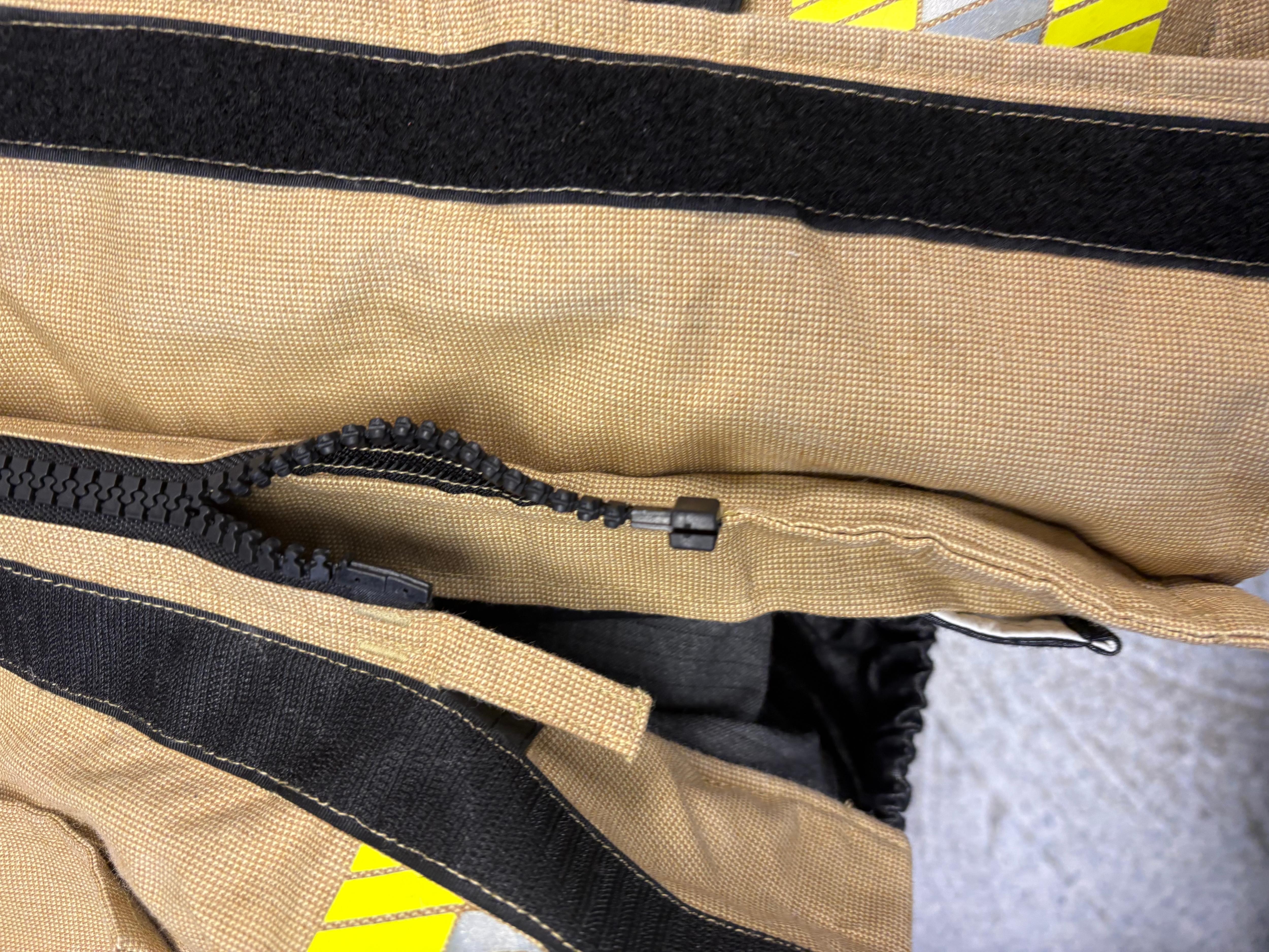 A faulty zipper on Metropolitan Fire Service personal protective equipment.