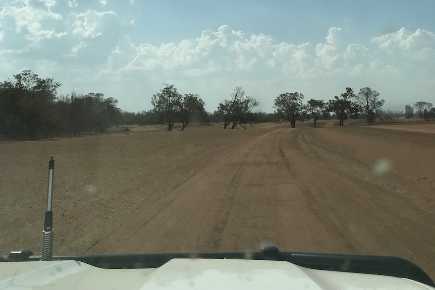 a car travelling on a dirt road