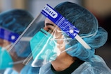 A medical personnel is pictured wearing a BYD Care N95 particulate respirator mask and a face shield.
