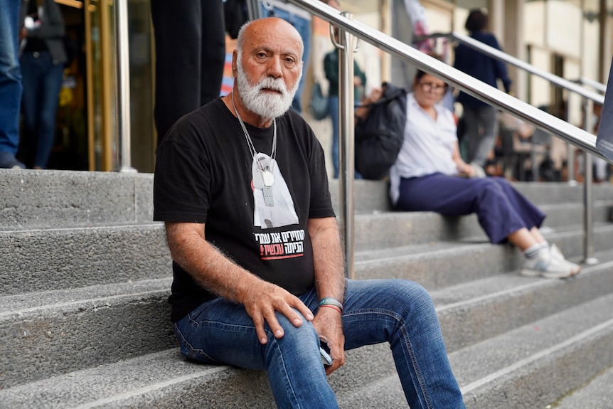 A man sits on the steps in Tel Aviv 
