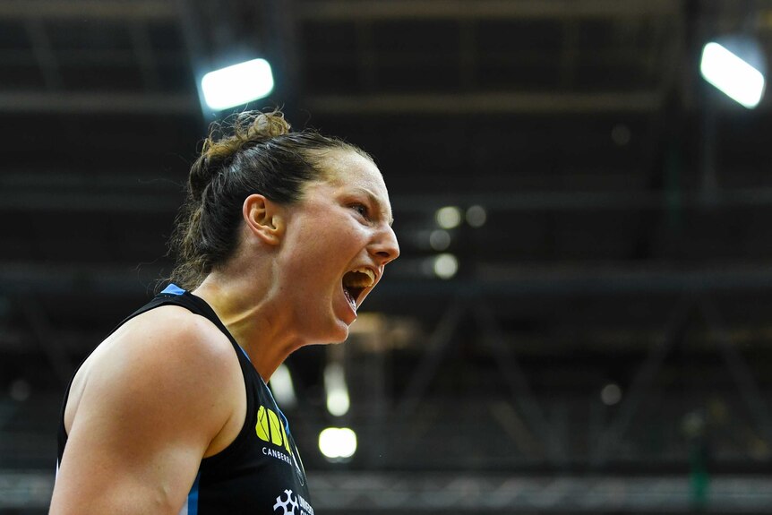 Kelsey Griffin screams out to the crowd as she celebrates during the WNBL grand final.