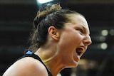 Kelsey Griffin screams out to the crowd as she celebrates during the WNBL grand final.