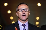Greens Party leader Richard Di Natale mid-sentence speaking to parliament house reporters