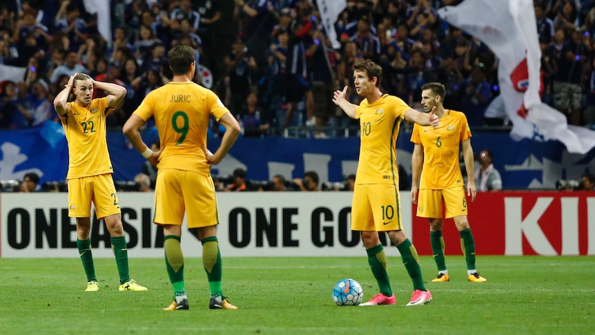Socceroos players react to Japan's second goal in their World Cup qualifier in Saitama