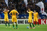 Socceroos players react to Japan's second goal in their World Cup qualifier in Saitama
