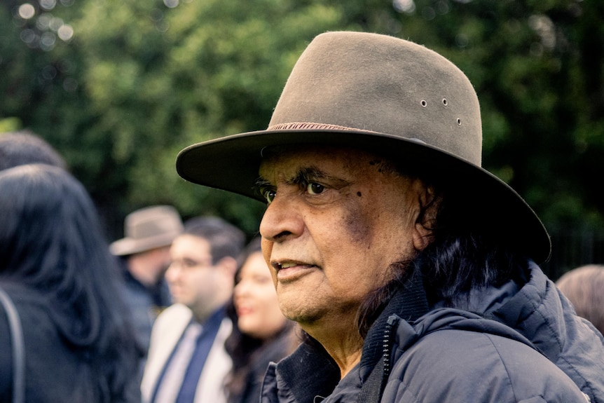 Gary Murray, wearing a hat, appears thoughtful as he stands outside.