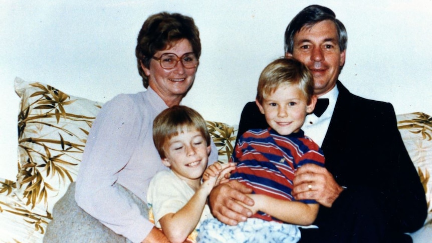 Ben Cox as a child with his father David, mother Patricia and his older brother Andrew sit together on a couch.
