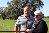 Bridget and Tim Goulding lean on a gate at their dairy farm in northern Victoria