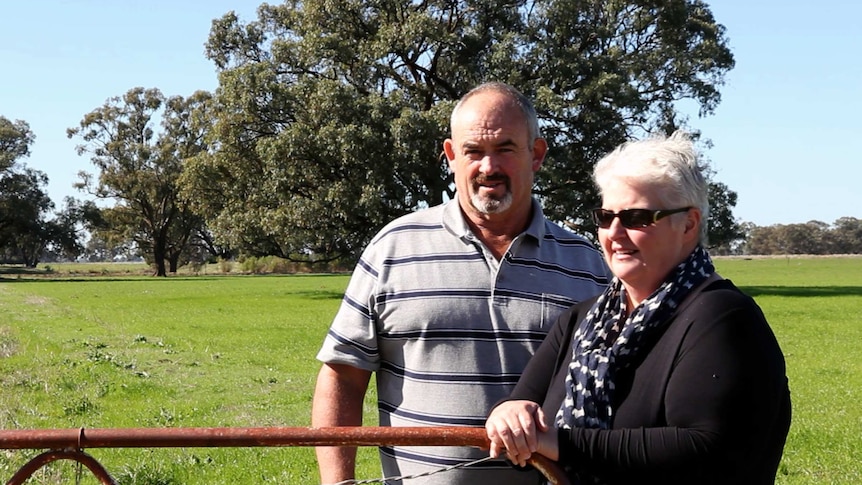 Bridget and Tim Goulding lean on a gate at their dairy farm in northern Victoria