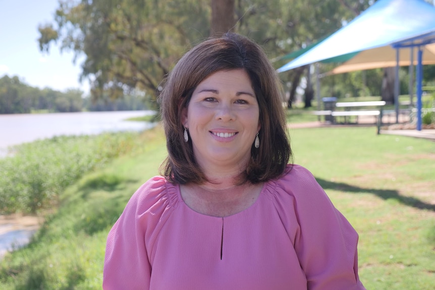 Samantha O'Toole is standing by the Balonne River.