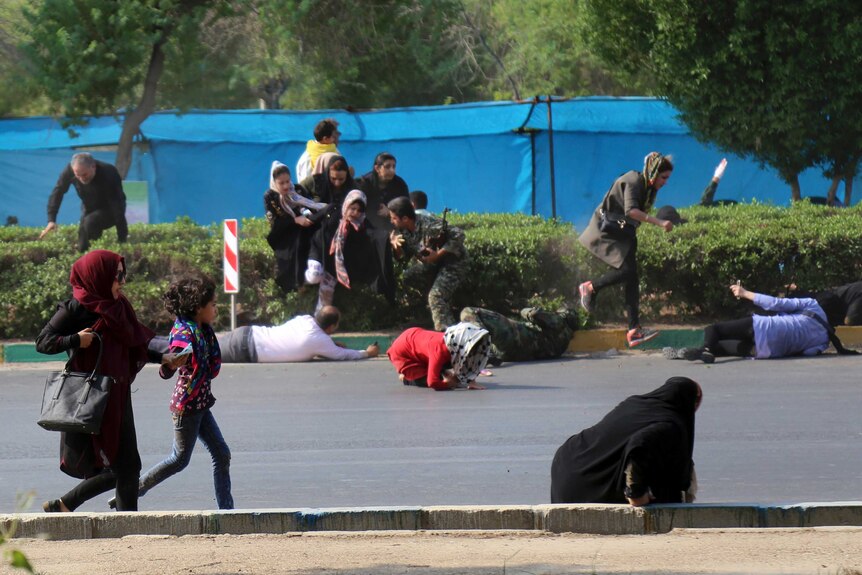 Civilians try to take shelter in a shooting scene