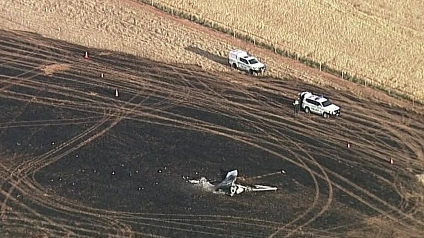 The remains of a small plane crashed into a charred paddock