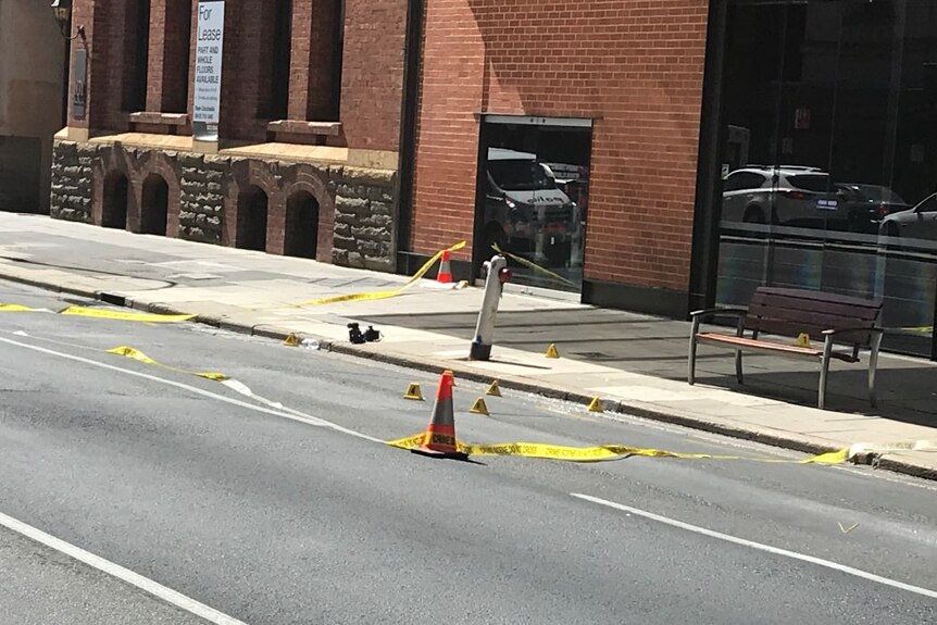 Cones and a crime scene set up on a road
