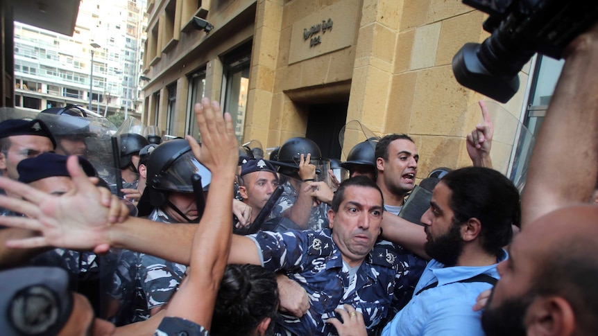 Lebanese activists clash with riot police outside the environment ministry in downtown Beirut