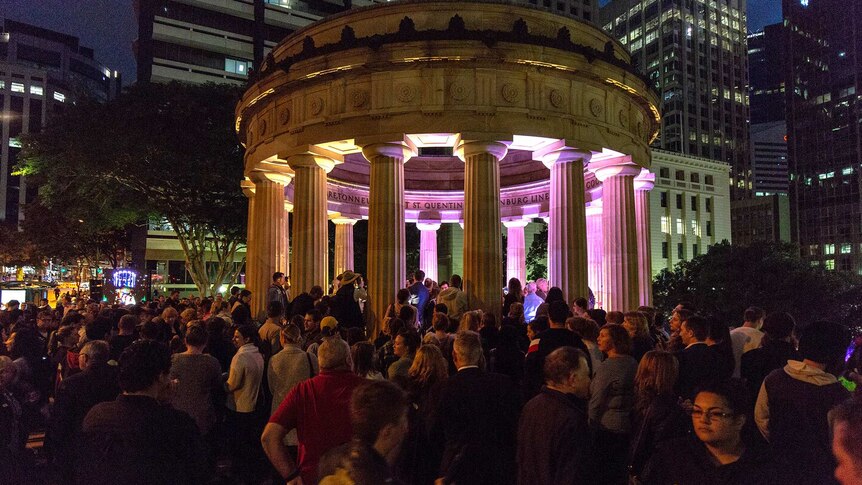 People line up to lay a wreath at the Shrine of Remembrance at Brisbane's Anzac Square.