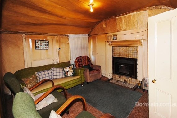 a sitting room in an old cottage in oatlands with sagging walls and ceilings