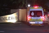 An ambulance outside an aged care home after dark