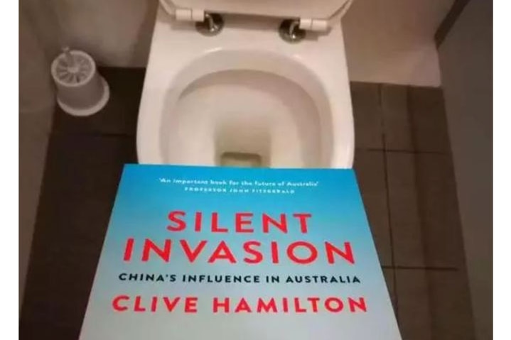 The book Silent Invasion is shown held above an open toilet