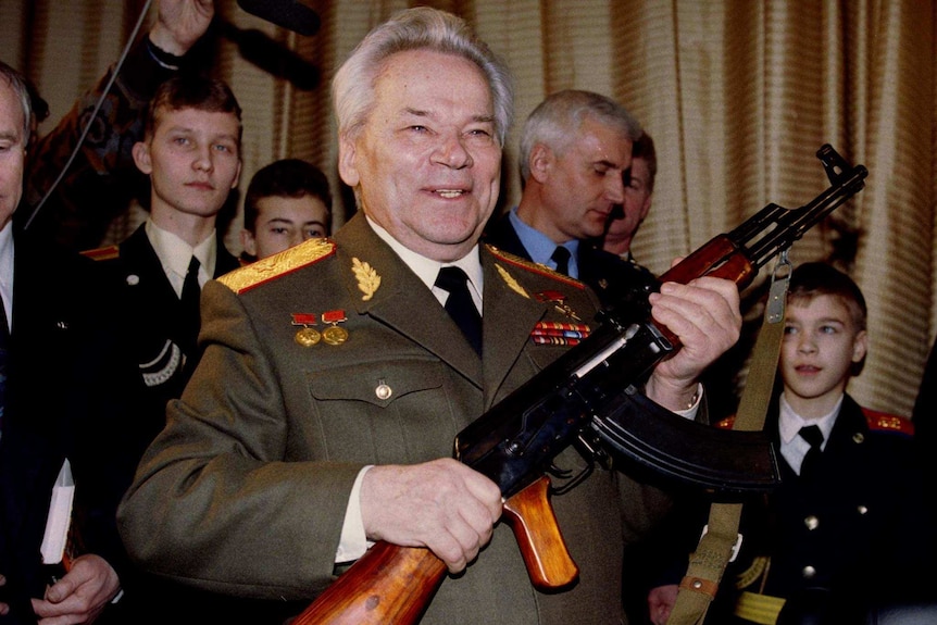 Mikhail Kalashnikov holds an AK-47