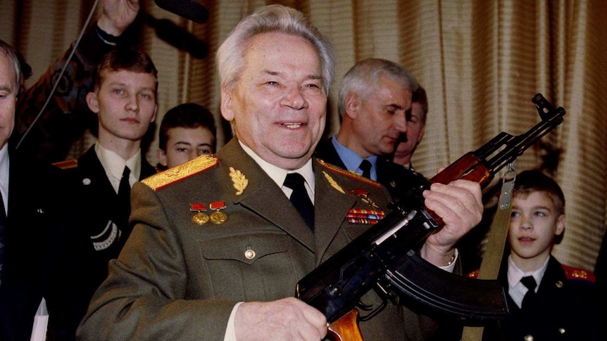 Mikhail Kalashnikov holds an AK-47