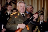 Mikhail Kalashnikov holds an AK-47