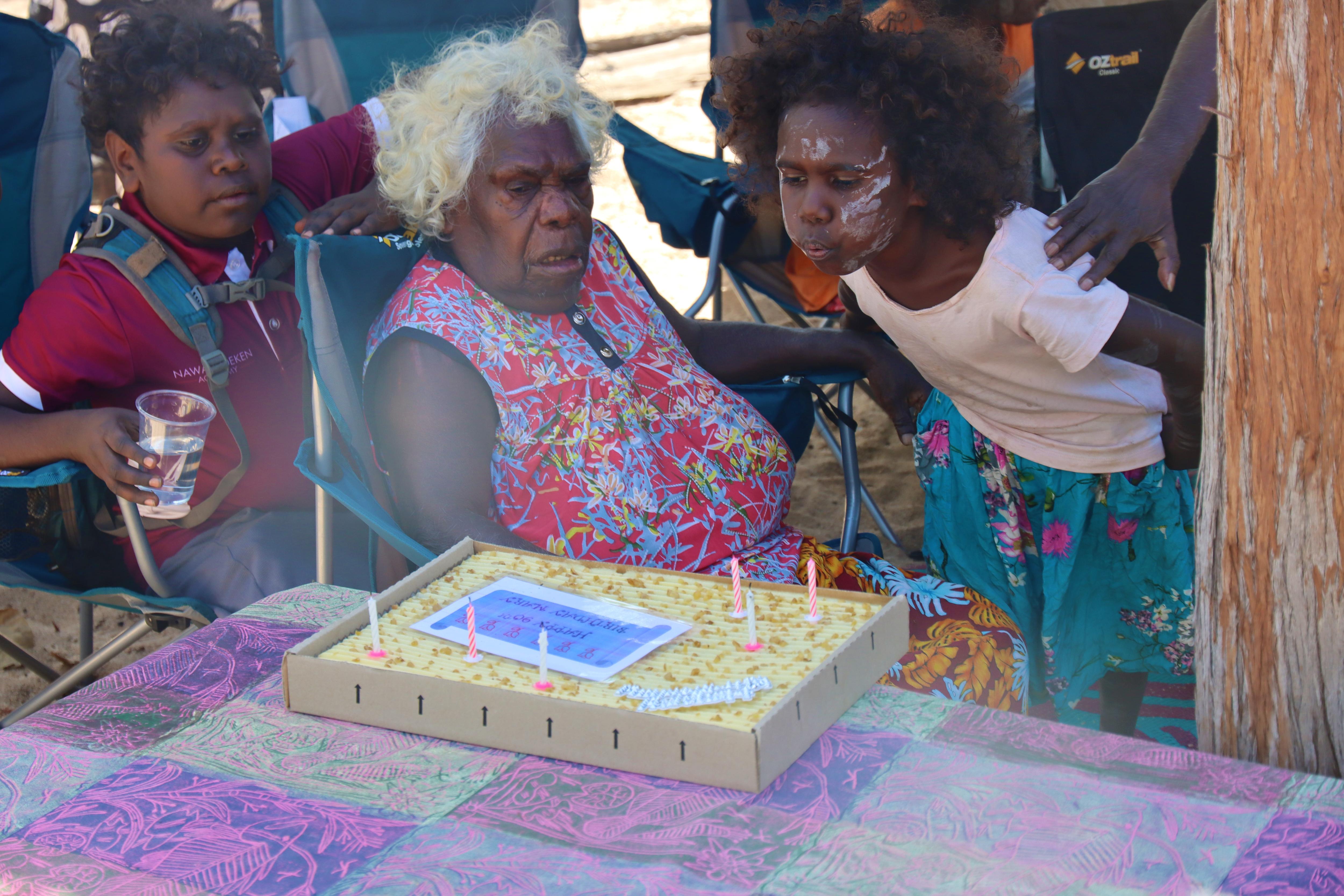 Mary Nadjamerrek sits behind her birthday cake.