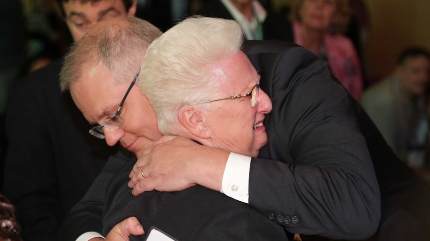 Prime Minister Scott Morrison embraces a woman after the formal apology to abuse survivors.