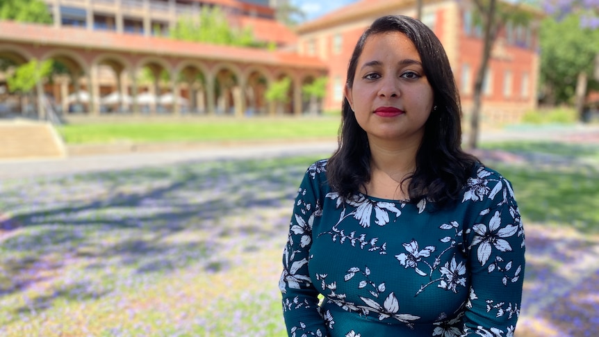 A woman on the grounds of Adelaide University.