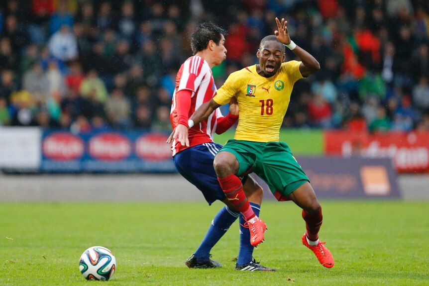 Enoh vies for the ball against Paraguay