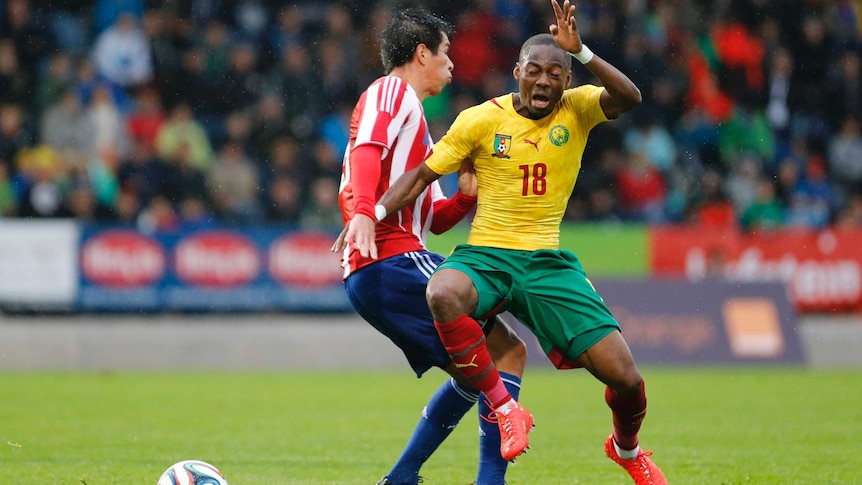 Enoh vies for the ball against Paraguay